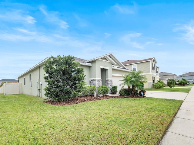 view of front of property with a front lawn and a garage