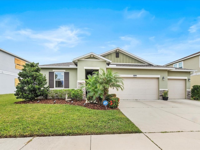 view of front of home with a garage and a front lawn