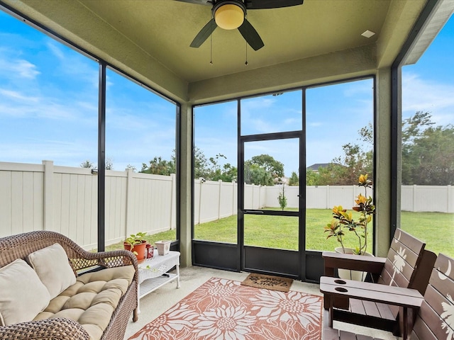 sunroom / solarium featuring ceiling fan