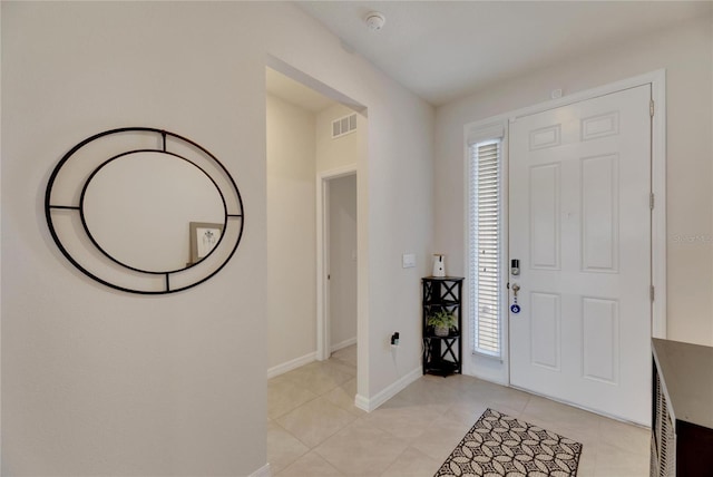 entrance foyer with a wealth of natural light and light tile patterned floors