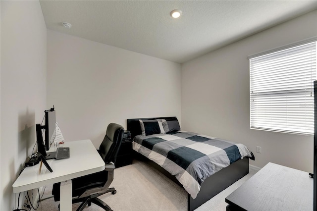 bedroom with carpet and a textured ceiling