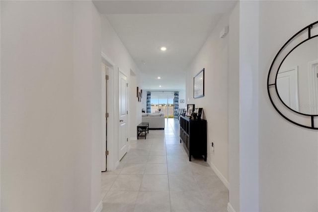 hall with light tile patterned floors