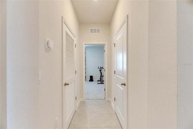 corridor with light tile patterned flooring