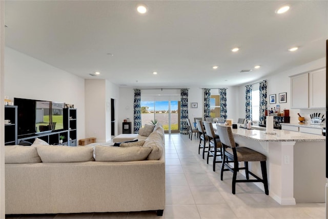 living room with a healthy amount of sunlight and light tile patterned flooring