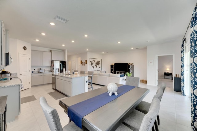 dining space featuring light tile patterned floors