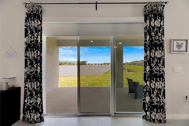 entryway with a water view and light tile patterned floors