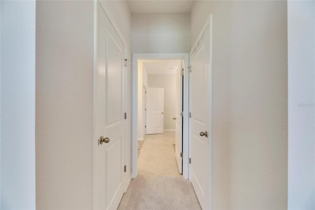 hall featuring light colored carpet