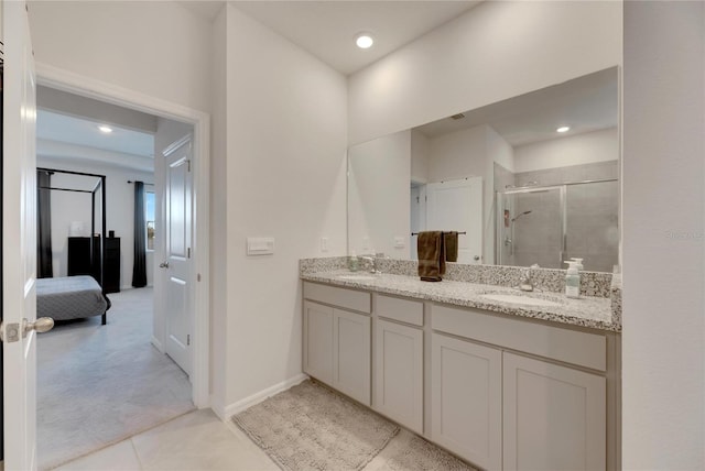 bathroom with tile patterned floors, vanity, and an enclosed shower