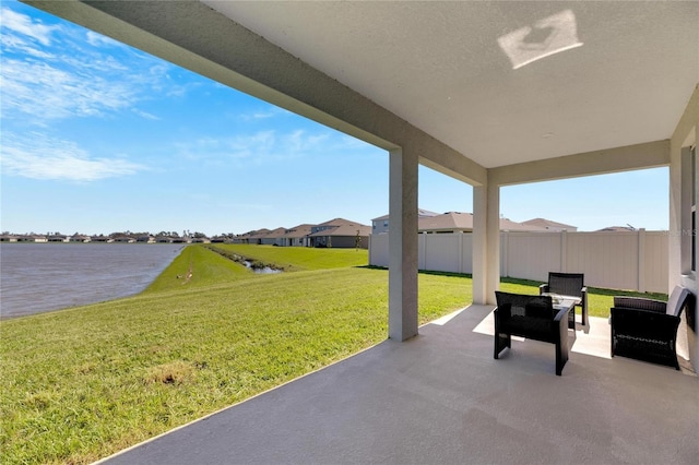 view of patio with a water view