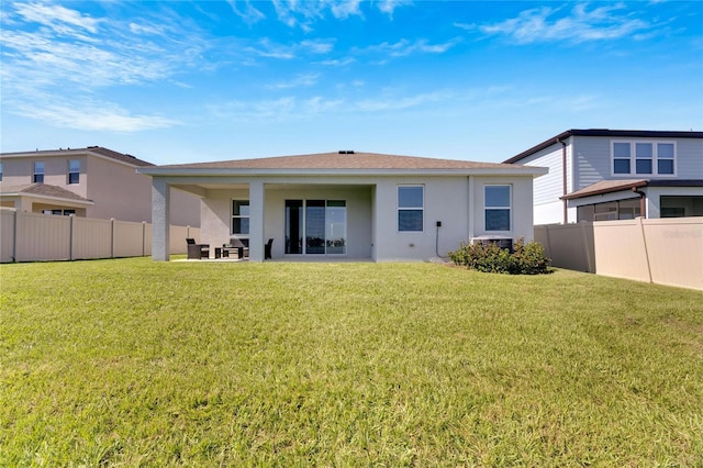 rear view of house featuring a patio and a lawn