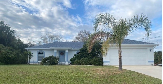 single story home with a garage and a front lawn