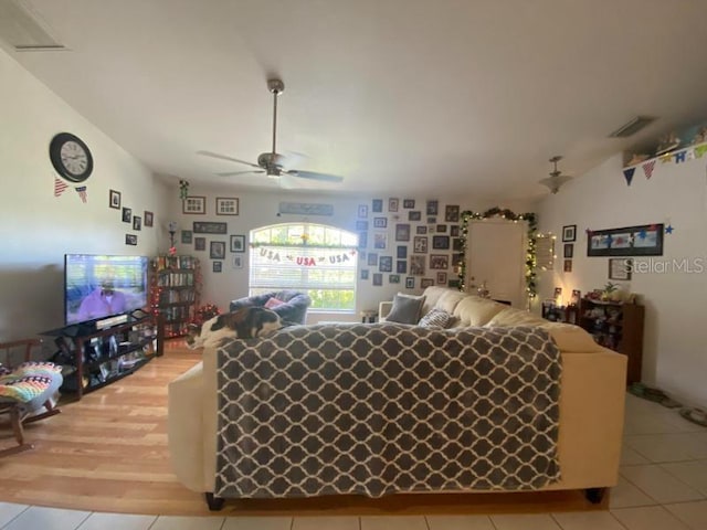 living room featuring ceiling fan and light wood-type flooring