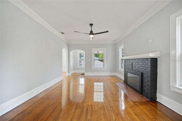 unfurnished living room with ornamental molding, a fireplace, and hardwood / wood-style flooring