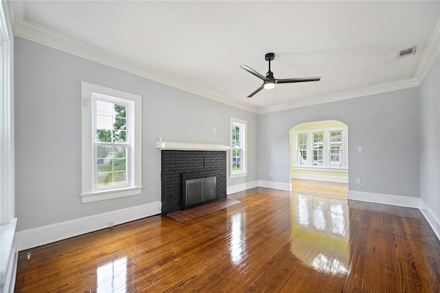 unfurnished living room featuring ornamental molding, hardwood / wood-style floors, and a healthy amount of sunlight