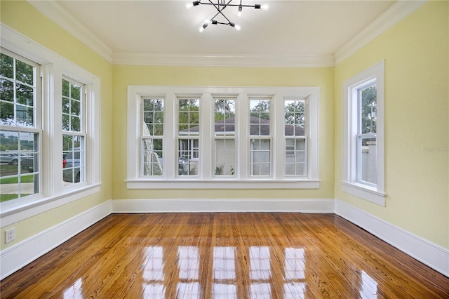 unfurnished sunroom featuring a wealth of natural light and an inviting chandelier