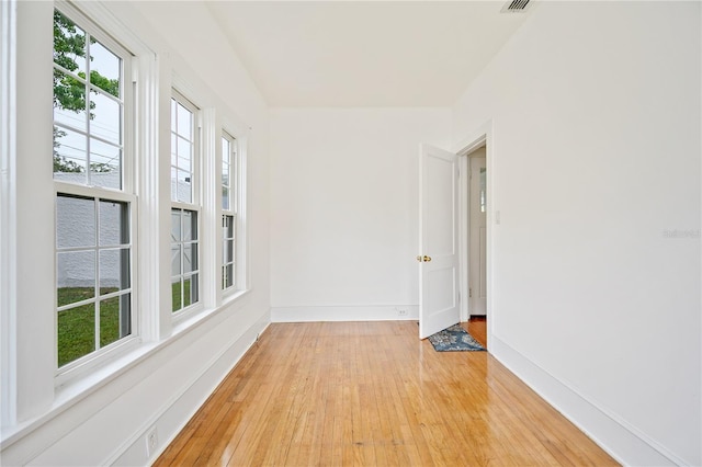 unfurnished room with light wood-type flooring