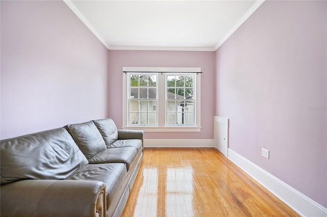 living room with light hardwood / wood-style floors and crown molding