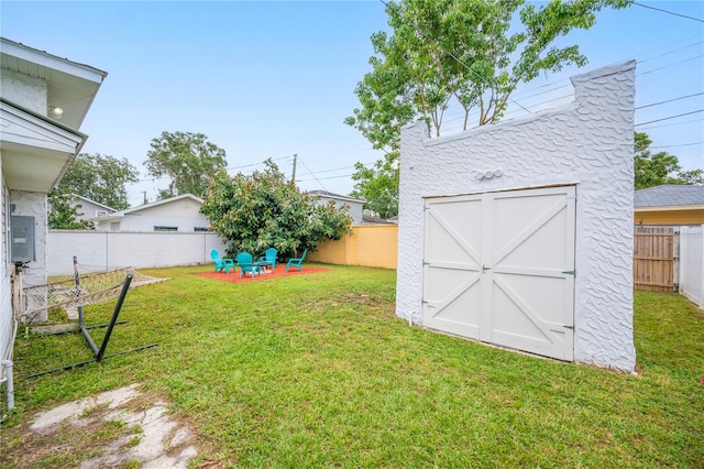 view of yard with a patio area and a storage shed