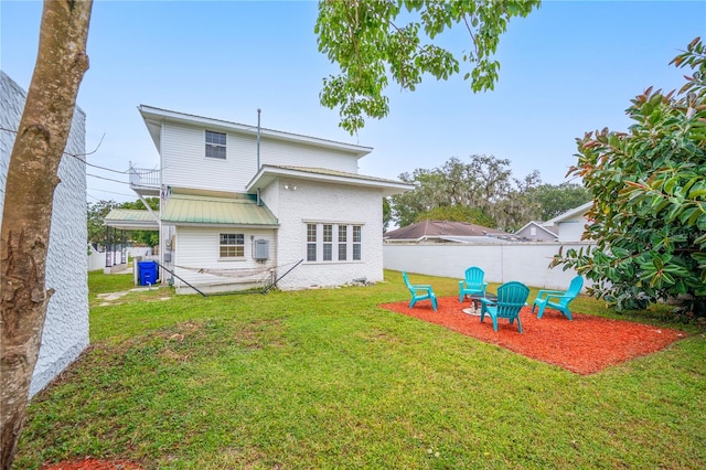 rear view of property featuring a patio area and a lawn