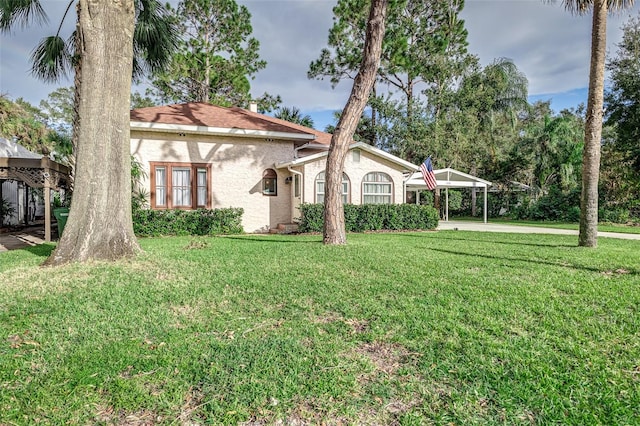 view of front facade with a carport and a front lawn