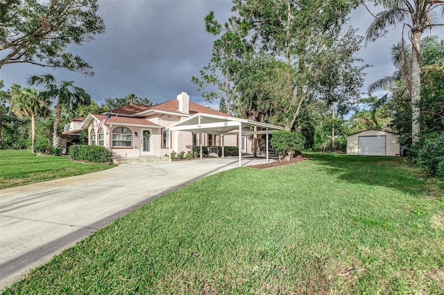 view of front of property with a front lawn, an outbuilding, a garage, and a carport