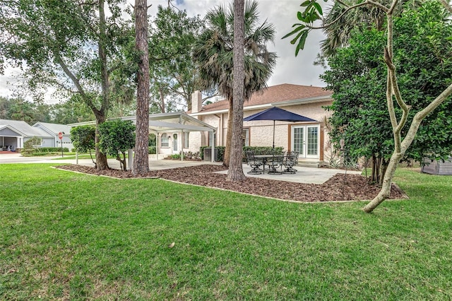 rear view of house featuring a yard and a patio