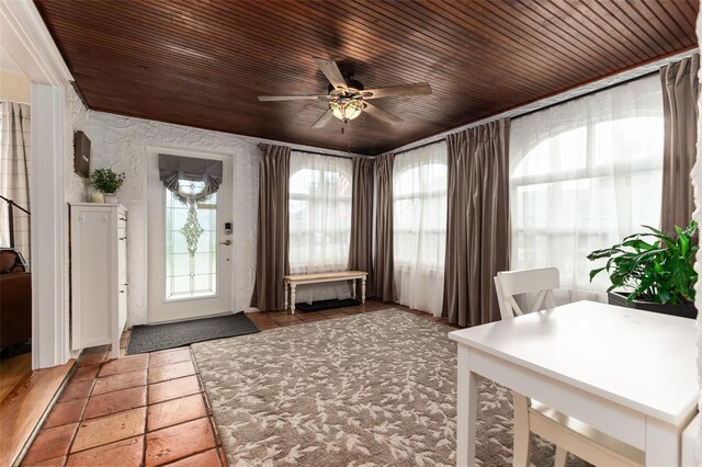 sunroom featuring ceiling fan and wooden ceiling