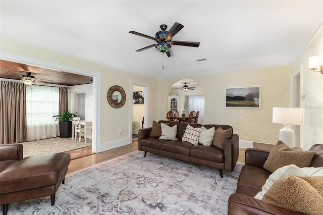 living room with ceiling fan and light wood-type flooring