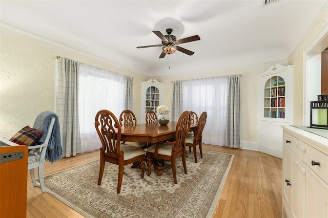 1806 17th St NW, Winter Haven, FL 33881 - dining room featuring light wood finished floors, ceiling fan, baseboards, and a textured wall
