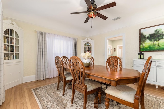 dining room with light hardwood / wood-style floors and ceiling fan