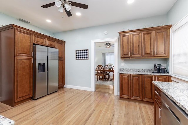 1806 17th St NW, Winter Haven, FL 33881 - kitchen with appliances with stainless steel finishes, a ceiling fan, light wood-style floors, light stone countertops, and recessed lighting