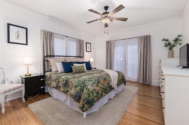 bedroom featuring ornamental molding, wood-type flooring, and ceiling fan