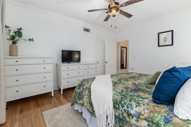 bedroom with ornamental molding, light hardwood / wood-style floors, and ceiling fan