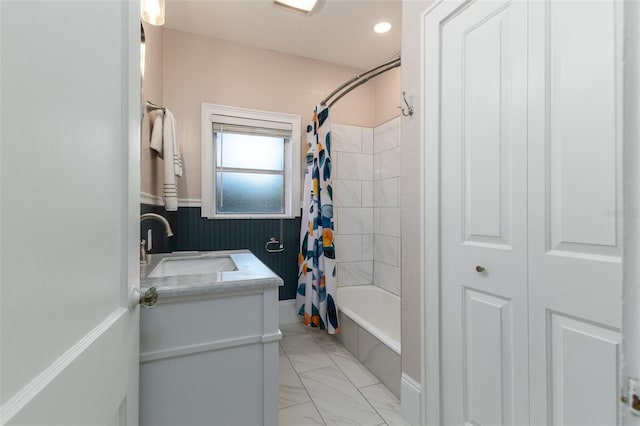 1806 17th St NW, Winter Haven, FL 33881 - full bathroom featuring shower / bath combo, marble look tile flooring, a wainscoted wall, and vanity