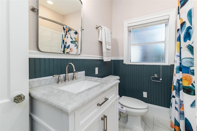 1806 17th St NW, Winter Haven, FL 33881 - full bathroom featuring a wainscoted wall, marble look tile flooring, vanity, a shower with shower curtain, and toilet