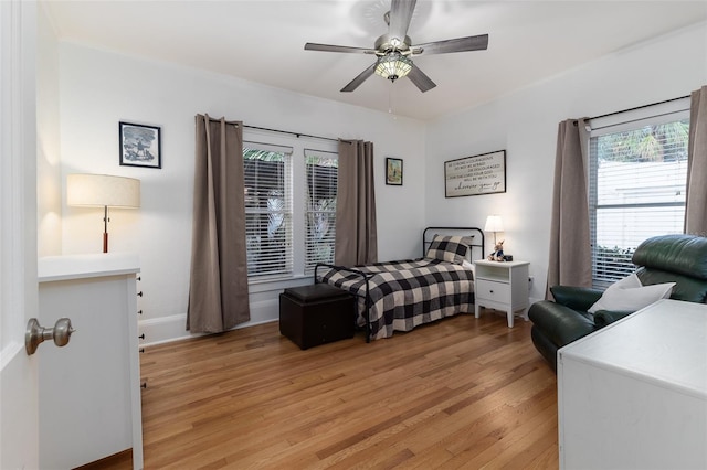 bedroom with light hardwood / wood-style floors and ceiling fan