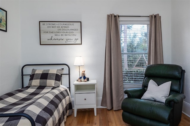 bedroom with hardwood / wood-style flooring