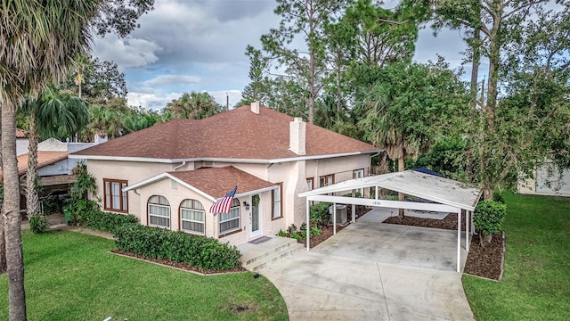 1806 17th St NW, Winter Haven, FL 33881 - view of front of house with driveway, a chimney, a front yard, and stucco siding