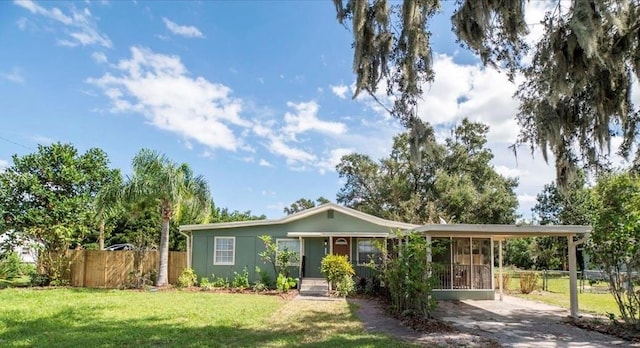 single story home with a front lawn and a carport