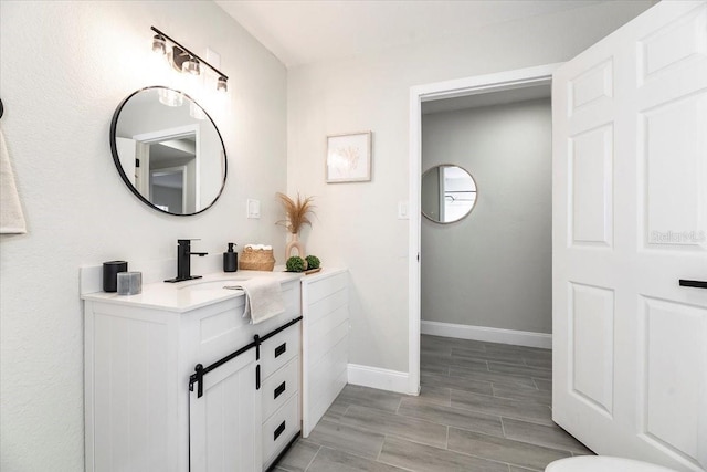 bathroom featuring vanity and hardwood / wood-style flooring