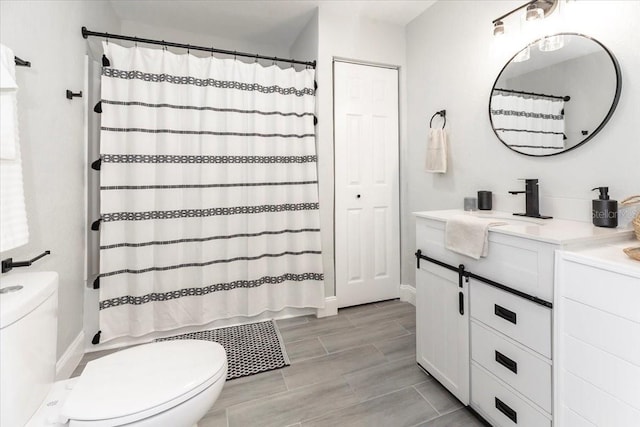 bathroom featuring vanity, toilet, and a shower with curtain