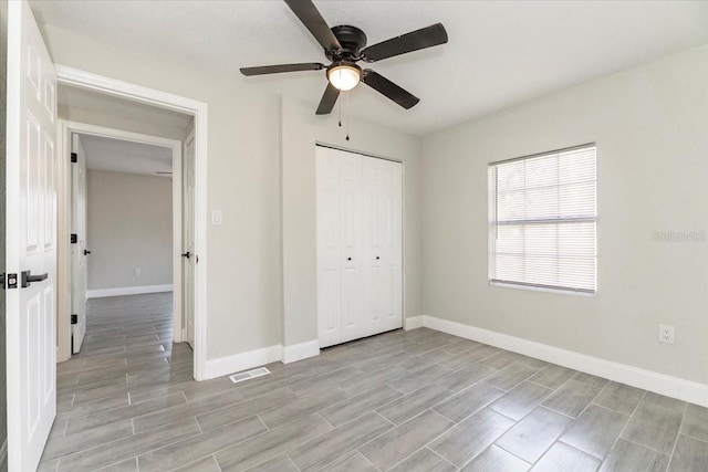 unfurnished bedroom featuring a closet, light wood-type flooring, and ceiling fan