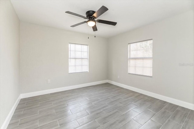 empty room featuring ceiling fan, light hardwood / wood-style flooring, and plenty of natural light