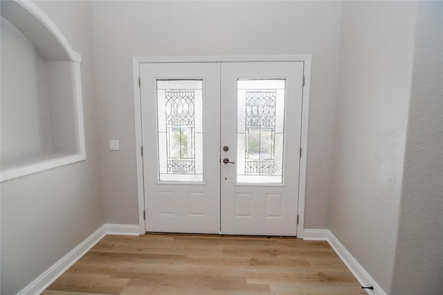 entryway with french doors and light wood-type flooring