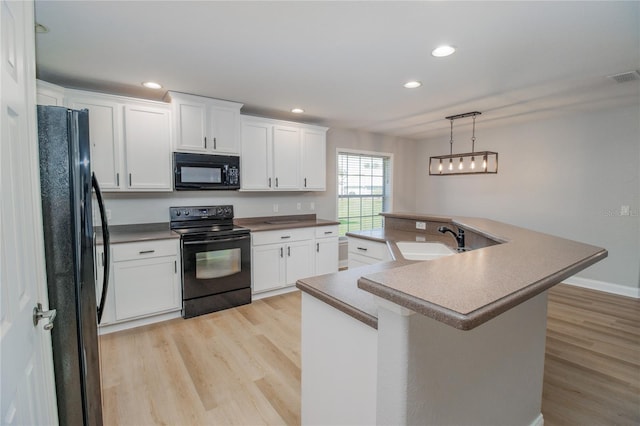 kitchen with black appliances, sink, white cabinetry, light hardwood / wood-style floors, and pendant lighting