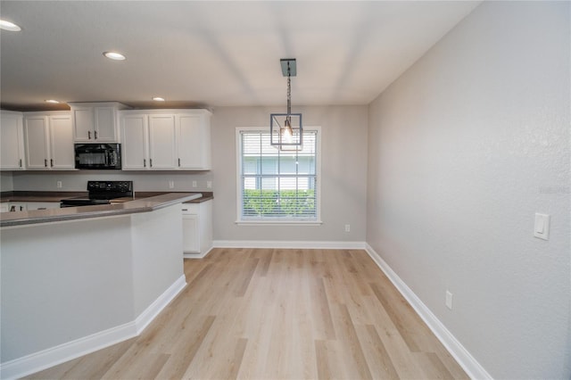 300 Winona Ct, Auburndale, FL 33823 - kitchen featuring black appliances, light wood-type flooring, white cabinets, baseboards, and recessed lighting