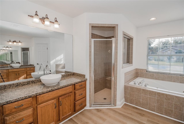 bathroom featuring vanity, hardwood / wood-style floors, and shower with separate bathtub