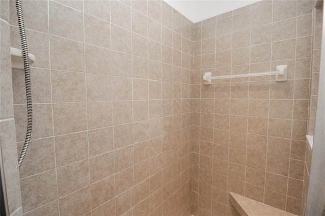 bathroom with tiled shower