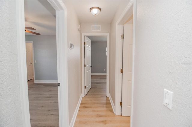 hallway with light wood-type flooring