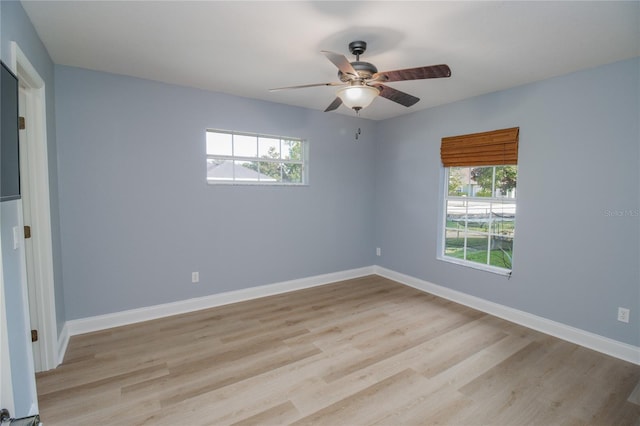 spare room featuring ceiling fan, plenty of natural light, and light wood-type flooring